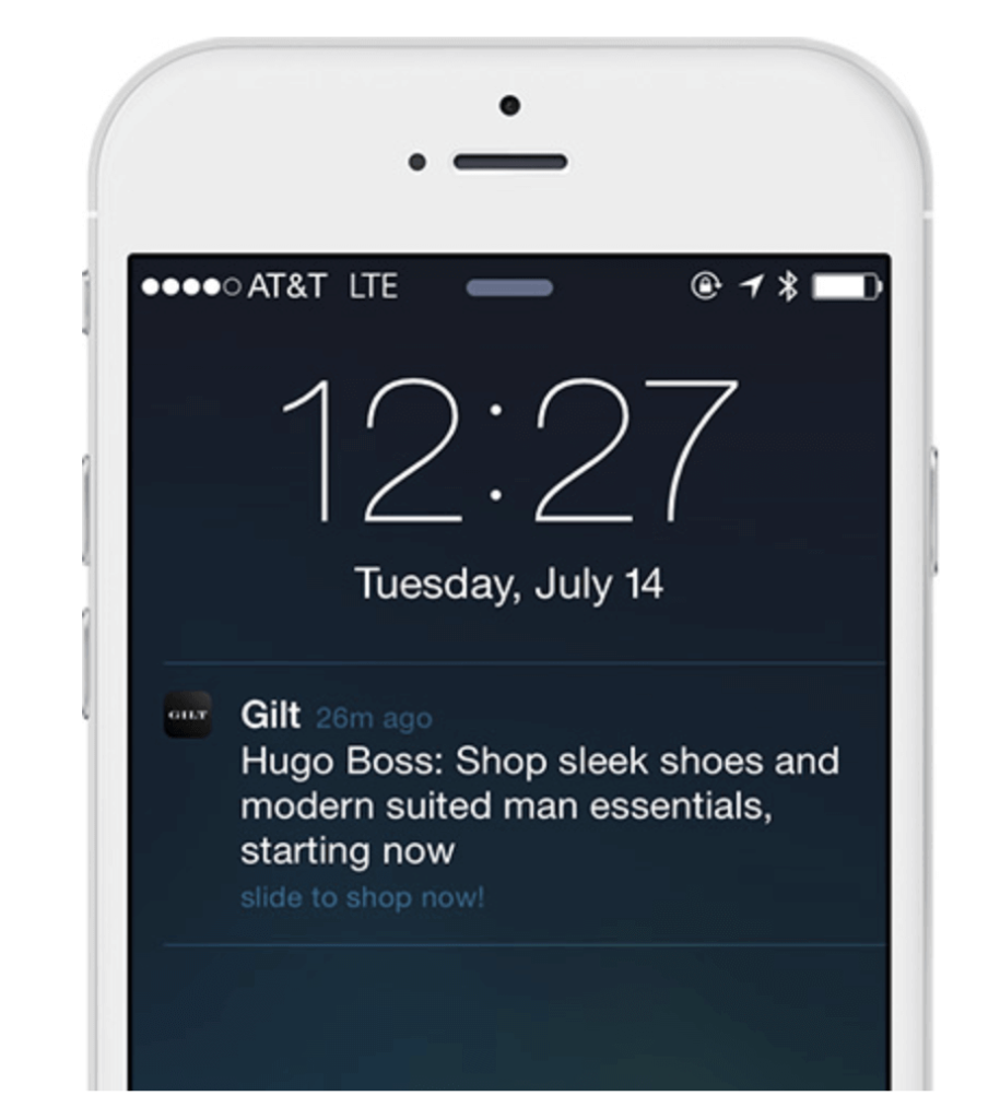 A smartphone displaying a push notification from Gilt.