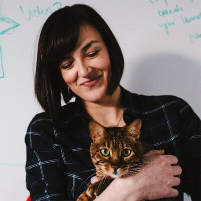 A women holding a tabby cat