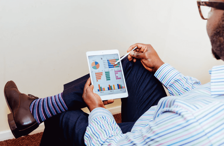 Man looking at data on a tablet