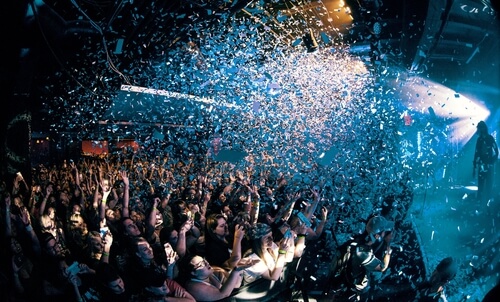 Picture of an audience getting confetti dumped on them